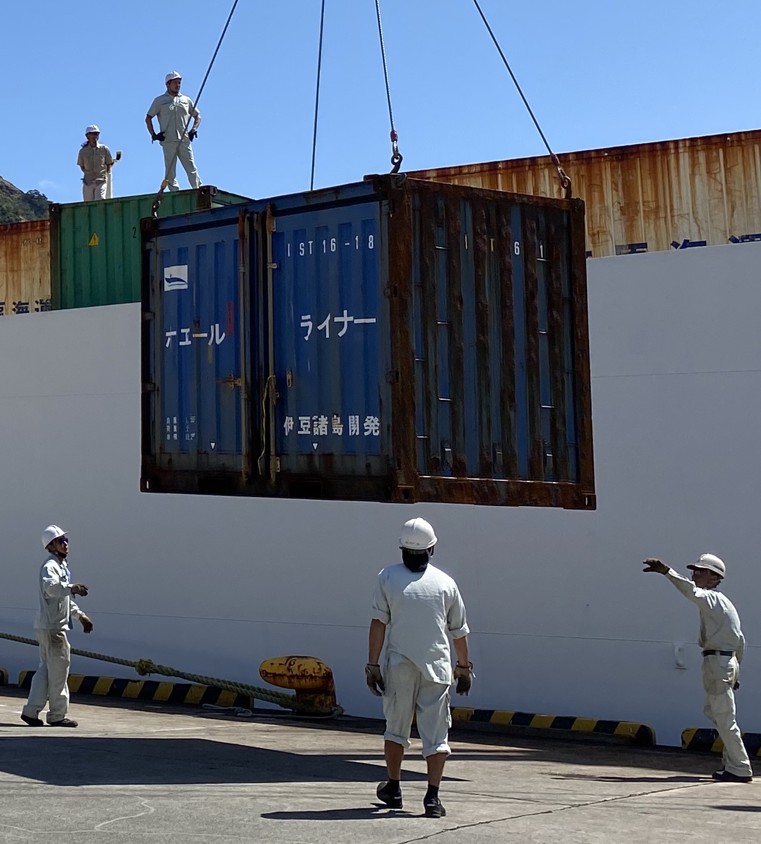 Men handling a shipping container
